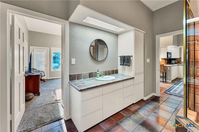 119 Stageline Dr, Kyle, TX 78640 - bathroom with backsplash, baseboards, and vanity