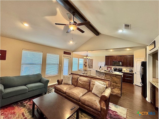 living room featuring a water view, vaulted ceiling with beams, ceiling fan with notable chandelier, and dark hardwood / wood-style floors