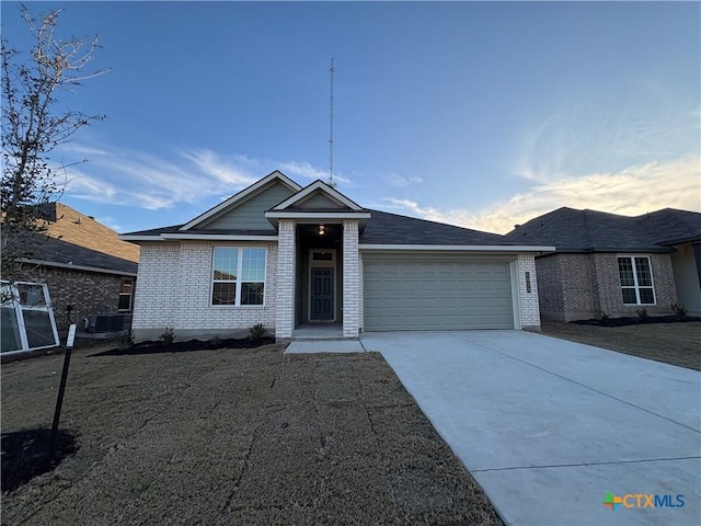 view of front of house with a garage and central AC unit