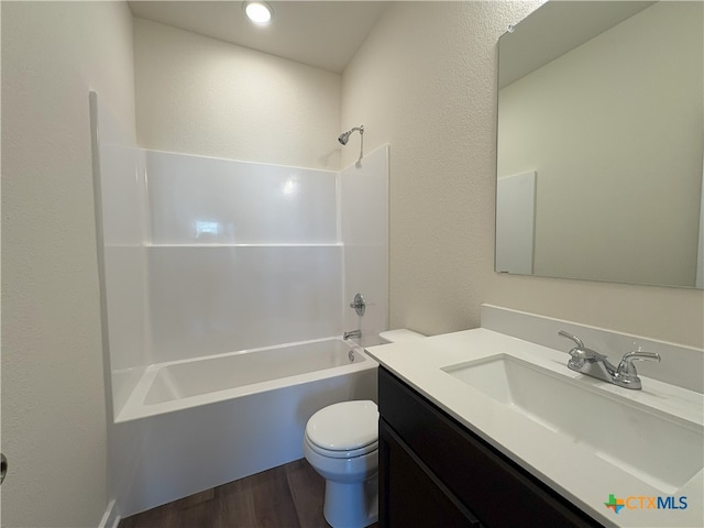 full bathroom featuring hardwood / wood-style flooring, toilet, vanity, and  shower combination