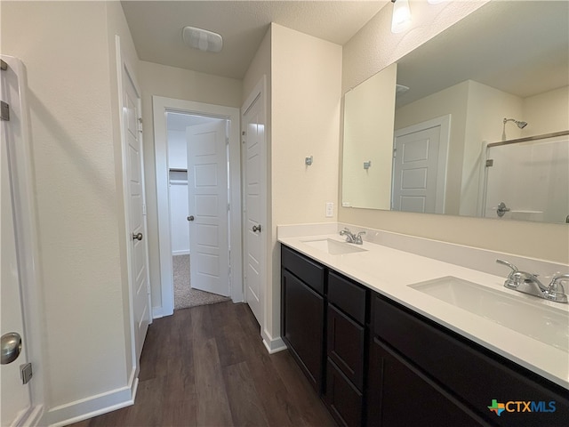 bathroom featuring vanity, hardwood / wood-style flooring, and walk in shower