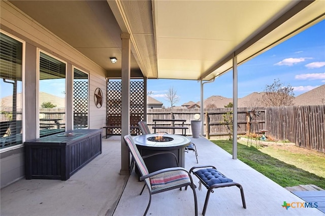 view of patio featuring fence and an outdoor fire pit