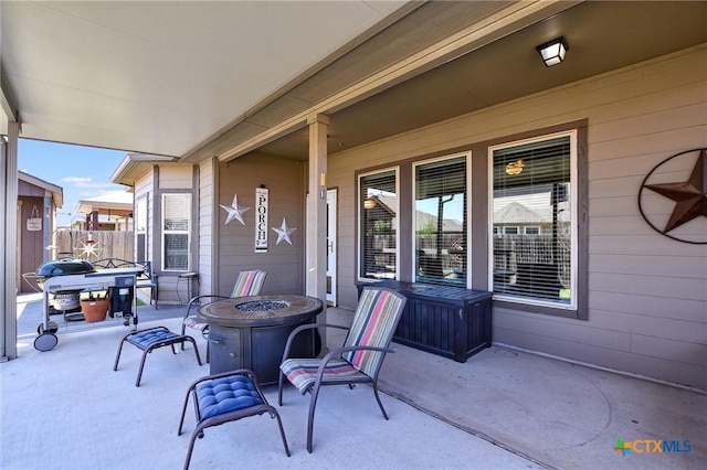 view of patio / terrace featuring a fire pit and fence