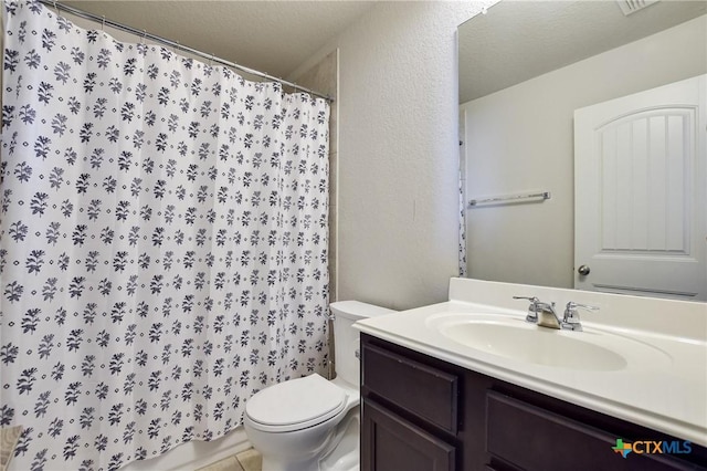 full bathroom featuring tile patterned floors, toilet, a textured ceiling, a shower with shower curtain, and vanity