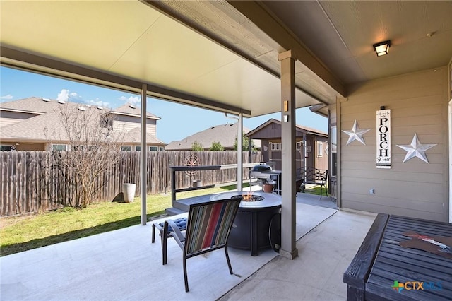 view of patio with an outbuilding, a fire pit, and a fenced backyard