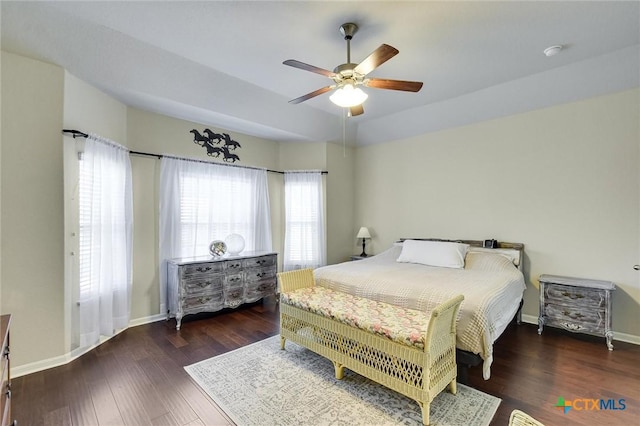 bedroom featuring a ceiling fan, wood finished floors, and baseboards