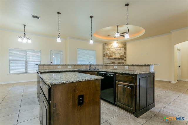 kitchen with a kitchen island, backsplash, dark brown cabinetry, dishwasher, and a tray ceiling