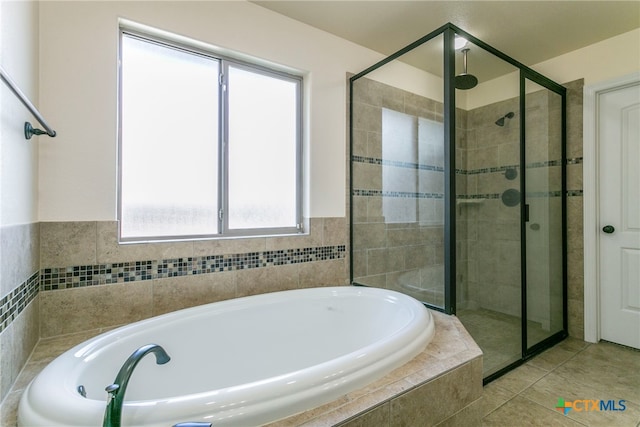 bathroom with tile patterned flooring and independent shower and bath