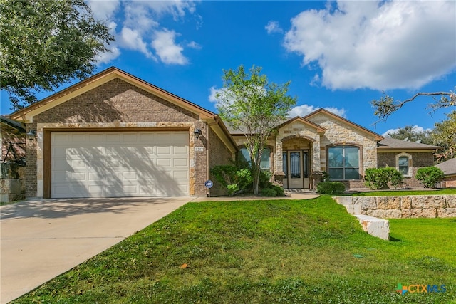 ranch-style home featuring a garage and a front lawn