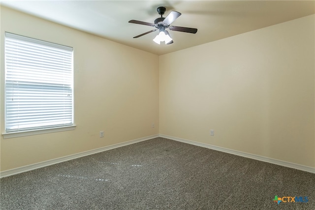 carpeted spare room featuring ceiling fan