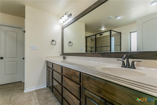 bathroom featuring vanity, a shower with door, and tile patterned floors