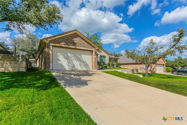 view of front of property featuring a garage and a front lawn