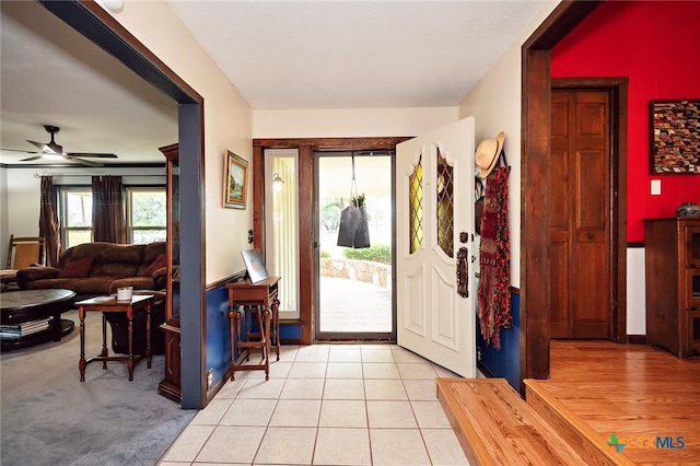 entrance foyer with ceiling fan and light tile patterned floors