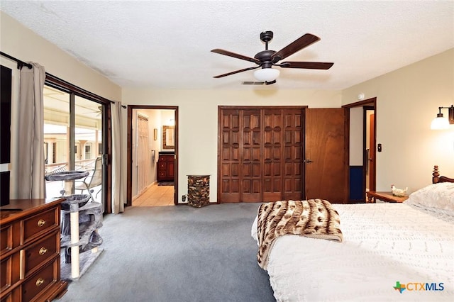 carpeted bedroom with a ceiling fan, ensuite bathroom, a closet, access to outside, and visible vents