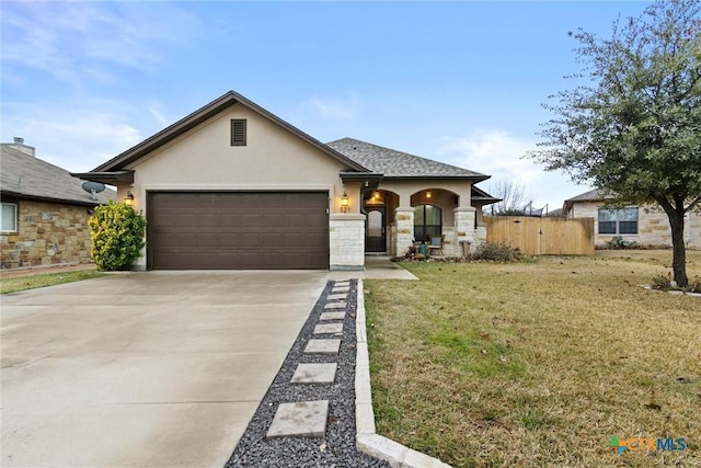 ranch-style home with a garage and a front lawn