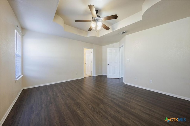 3907 Llano Estacado Ct, Killeen, TX 76549 - spare room featuring a raised ceiling, ceiling fan, and dark wood-style flooring