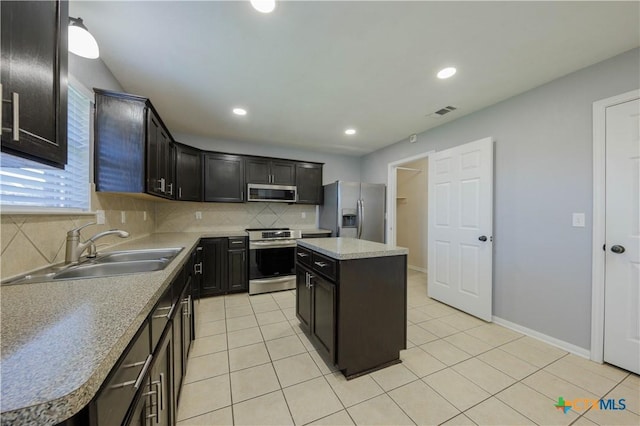 3907 Llano Estacado Ct, Killeen, TX 76549 - kitchen with stainless steel appliances, backsplash, light tile patterned floors, recessed lighting, and a center island