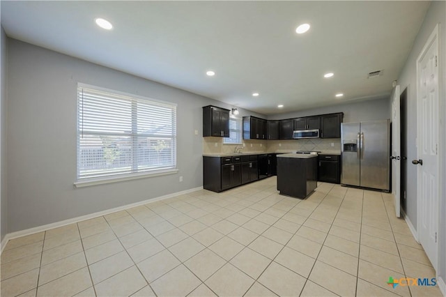 3907 Llano Estacado Ct, Killeen, TX 76549 - kitchen featuring appliances with stainless steel finishes, light countertops, backsplash, recessed lighting, and dark cabinetry