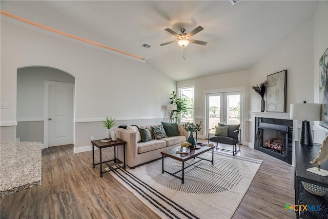 166 Lost Maples Way, Marion, TX 78124 - living room featuring a ceiling fan, arched walkways, a fireplace, lofted ceiling, and wood finished floors