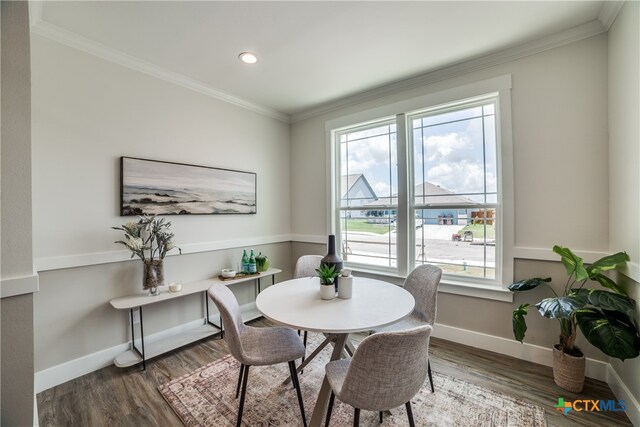 dining room featuring dark hardwood / wood-style floors and ornamental molding