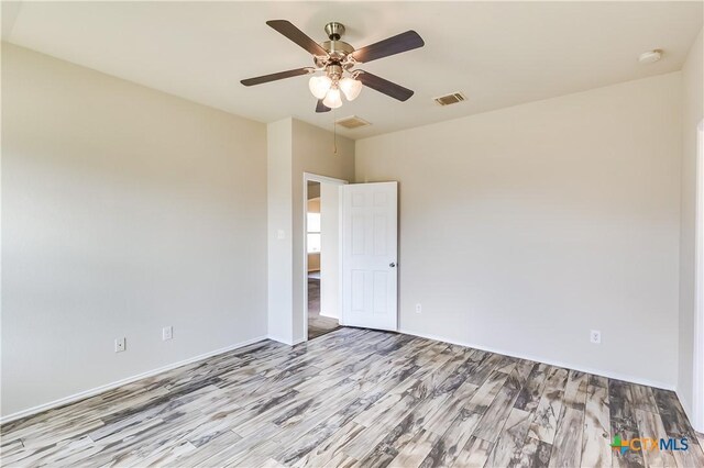 5402 Waterbank Ln, Killeen, TX 76543 - spare room featuring wood finished floors, a ceiling fan, baseboards, and a smoke detector