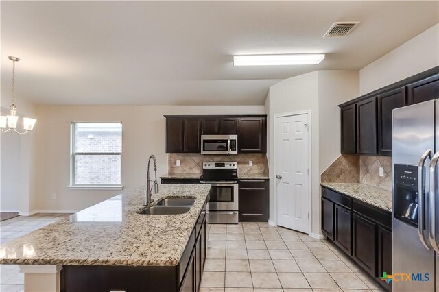 5402 Waterbank Ln, Killeen, TX 76543 - kitchen with stainless steel appliances, a sink, light tile patterned flooring, and tasteful backsplash