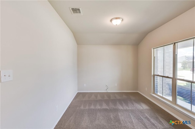 5402 Waterbank Ln, Killeen, TX 76543 - empty room featuring healthy amount of natural light, vaulted ceiling, carpet flooring, and baseboards