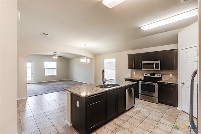 5402 Waterbank Ln, Killeen, TX 76543 - kitchen with appliances with stainless steel finishes, a sink, light tile patterned floors, a ceiling fan, and arched walkways