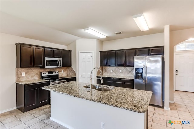 5402 Waterbank Ln, Killeen, TX 76543 - kitchen with stainless steel appliances, a sink, light tile patterned floors, light stone countertops, and dark brown cabinets
