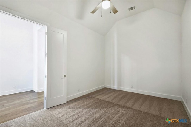 unfurnished room with carpet flooring, ceiling fan, and vaulted ceiling