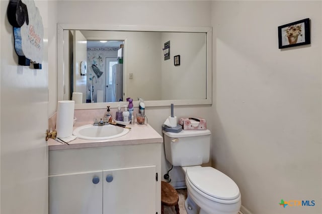 half bathroom featuring toilet and vanity