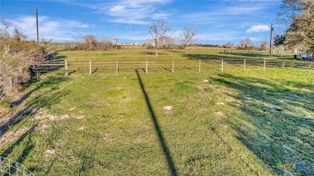 view of yard featuring a rural view and fence