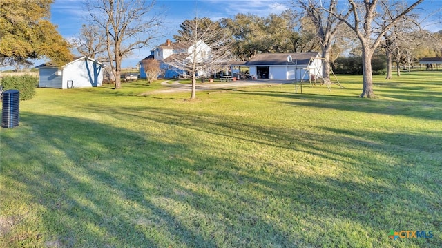 view of yard with a carport and an outdoor structure