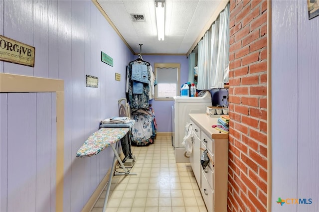 laundry area with independent washer and dryer, cabinet space, and visible vents