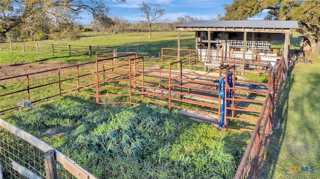 view of yard featuring a rural view, an exterior structure, and an outdoor structure