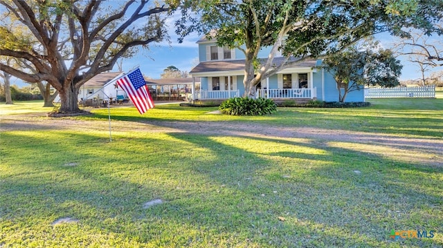 view of yard featuring fence and covered porch