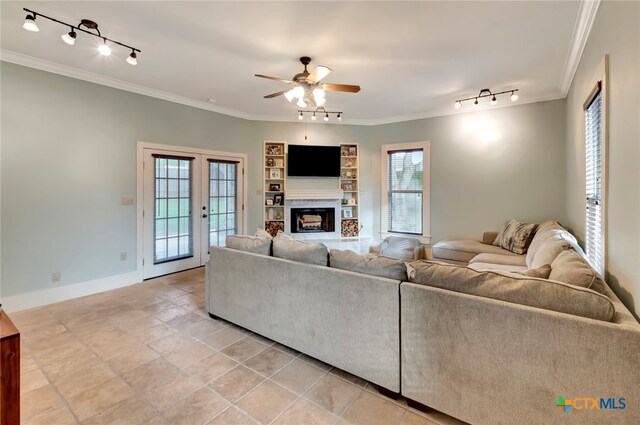 living room with ceiling fan, a healthy amount of sunlight, and crown molding