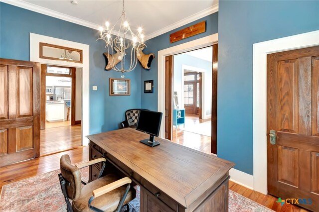 office featuring light hardwood / wood-style flooring, crown molding, and a notable chandelier