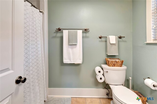 bathroom with tile patterned floors and toilet