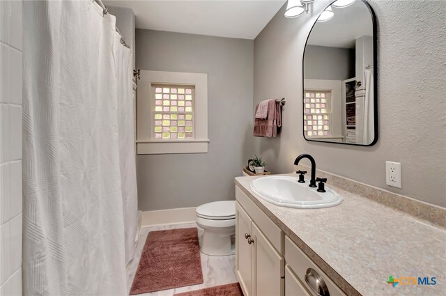 bathroom with vanity, tile patterned floors, and toilet