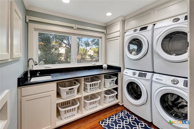 washroom featuring sink, ornamental molding, independent washer and dryer, stacked washer / dryer, and dark hardwood / wood-style flooring