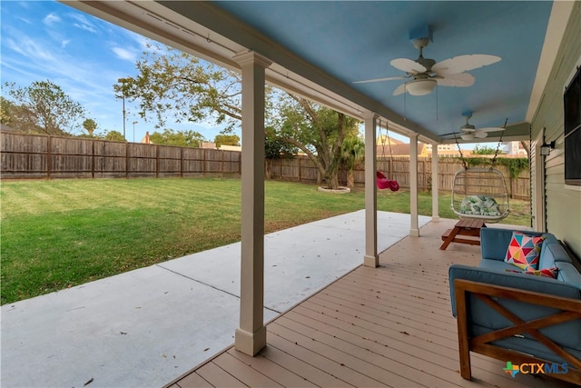 deck with a patio, a lawn, and ceiling fan