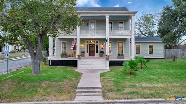 neoclassical / greek revival house featuring a front lawn and covered porch