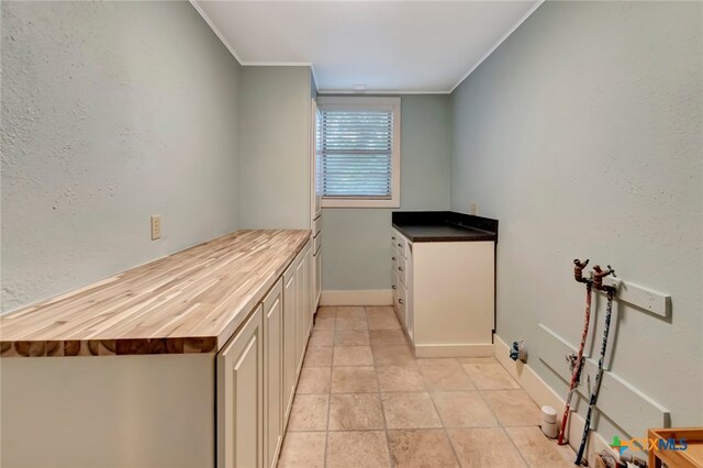 kitchen featuring butcher block countertops and crown molding