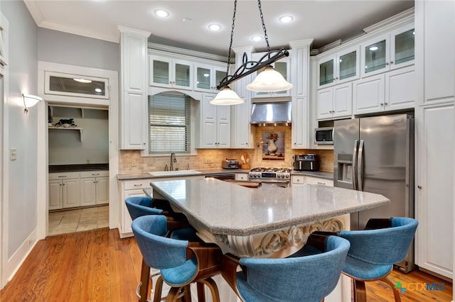 kitchen featuring white cabinets, stainless steel appliances, light hardwood / wood-style flooring, and sink