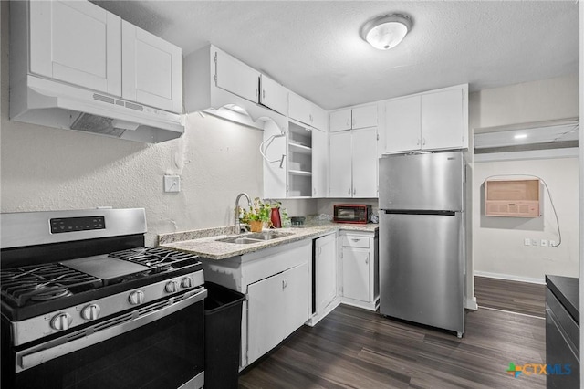 kitchen featuring a sink, light countertops, dark wood finished floors, stainless steel appliances, and under cabinet range hood