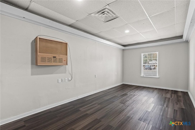 unfurnished room with visible vents, a paneled ceiling, baseboards, and wood finished floors