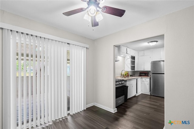 kitchen featuring open shelves, white cabinets, a sink, dark wood finished floors, and stainless steel appliances