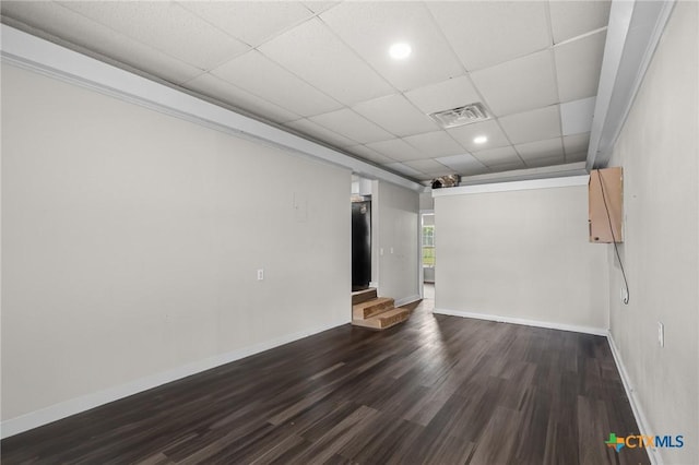 unfurnished room featuring a paneled ceiling, recessed lighting, baseboards, wood finished floors, and visible vents