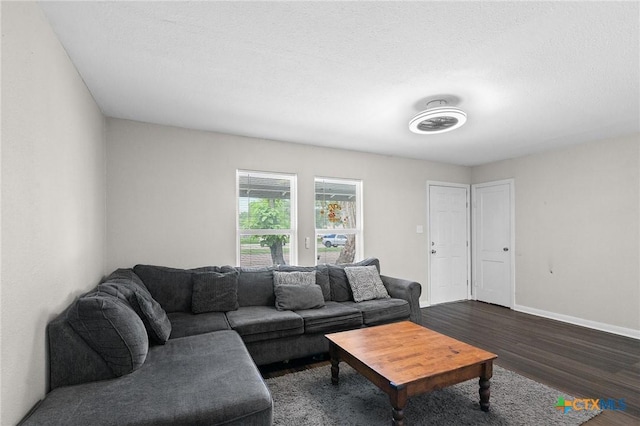 living area with baseboards and dark wood-style floors
